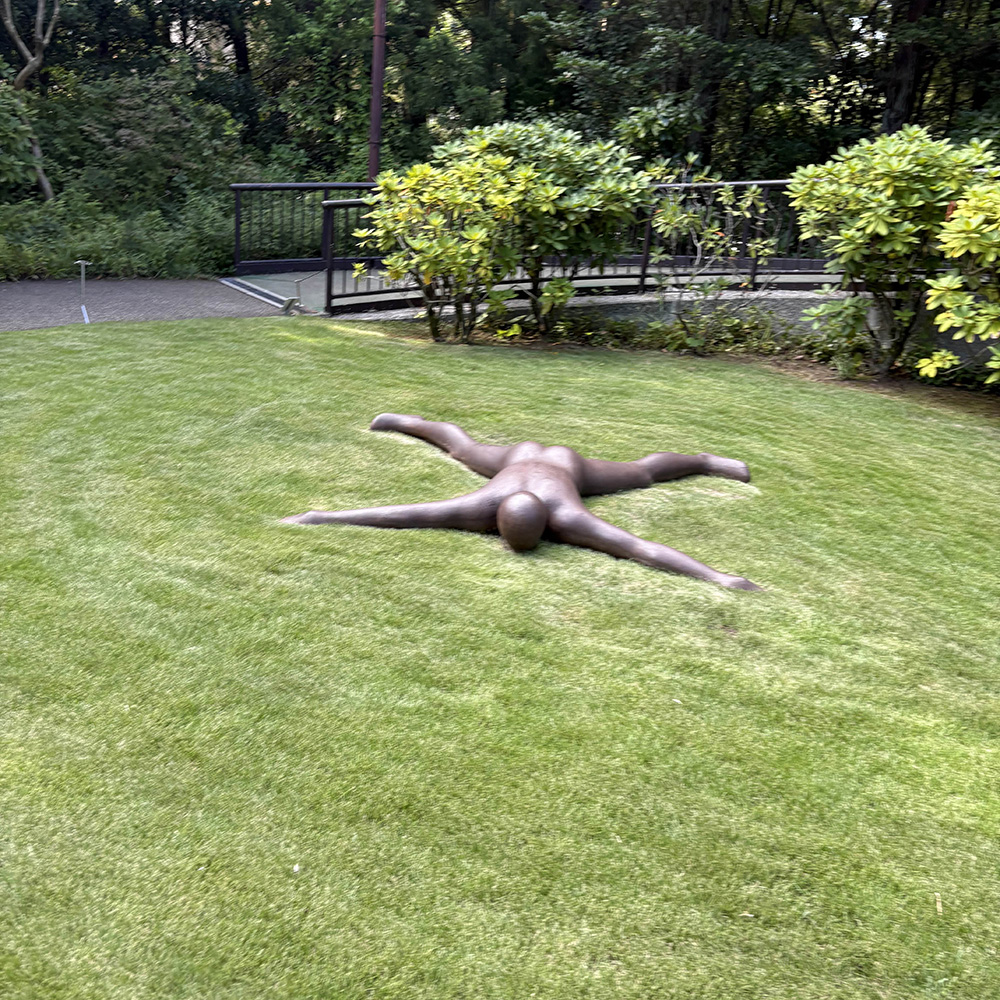 sculpture of man laying down