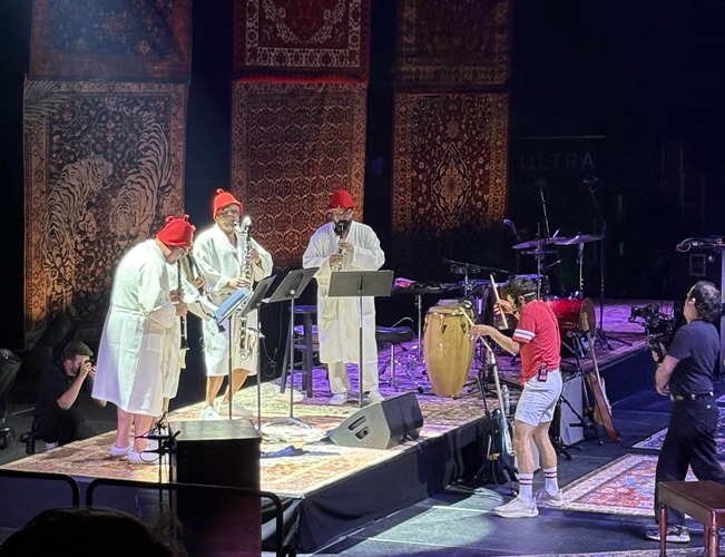Jack Stratton conducting with drum sticks at MSG